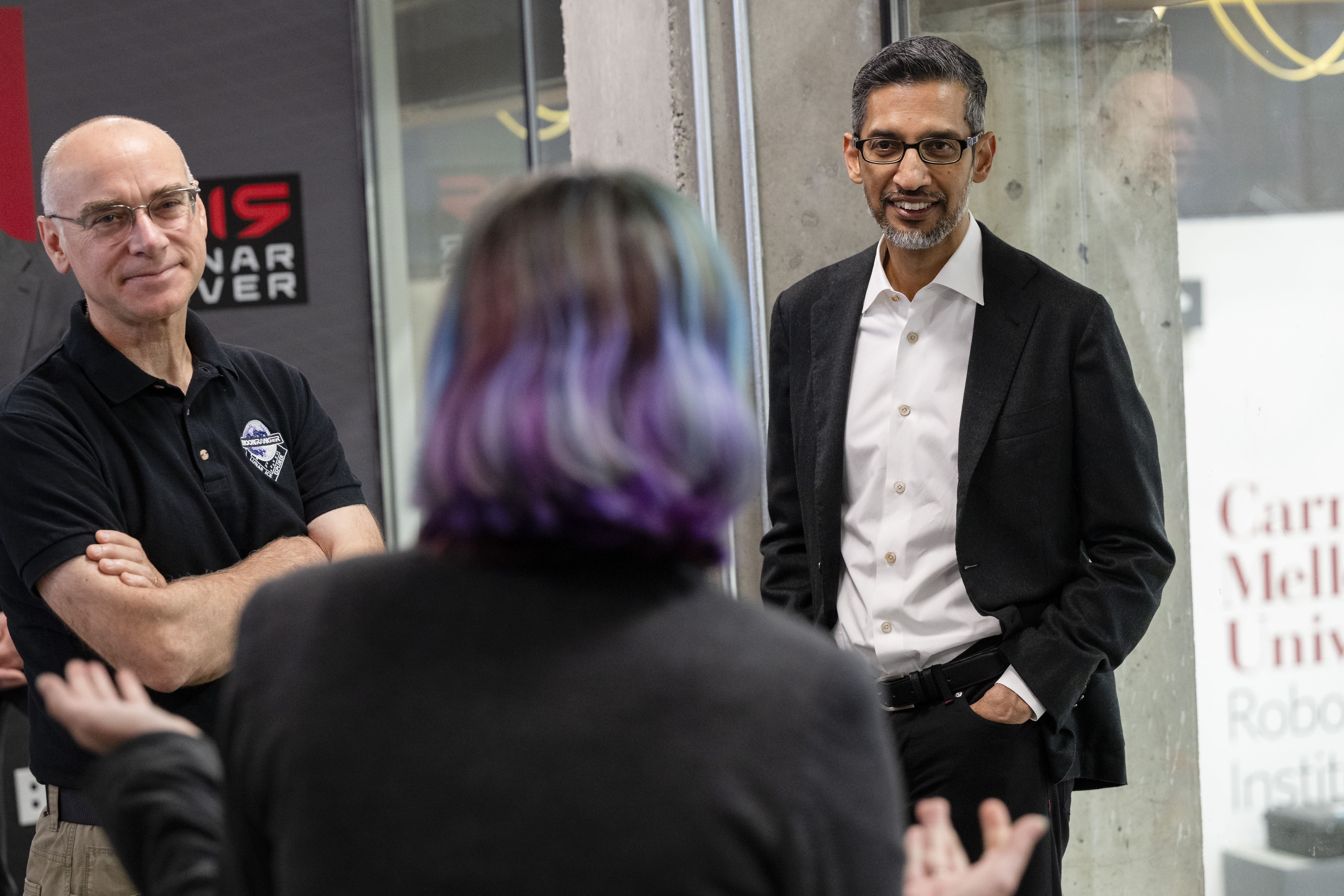 Duvall (center) talks to David Wettergreen (left), research professor in CMU's Robotics Institute, and Pichai.
