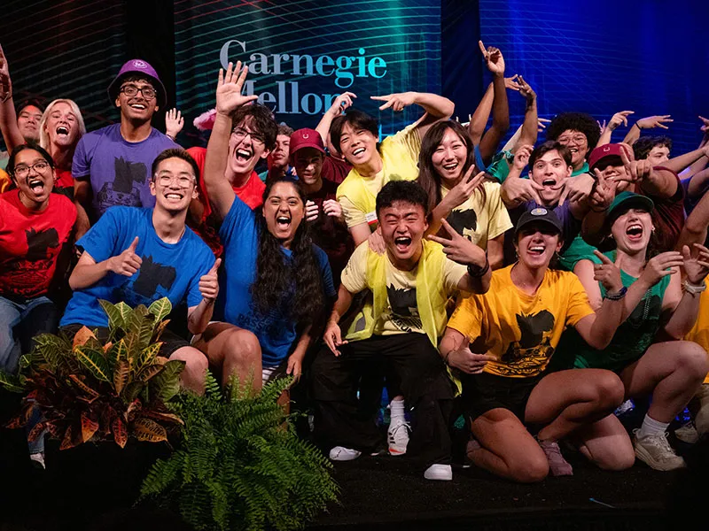 students celebrating on stage at the annual community collage event