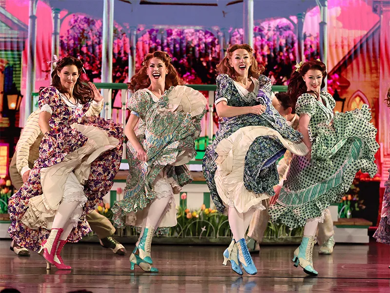 Ladies from Schmigadoon, on stage, swishing their skirts.