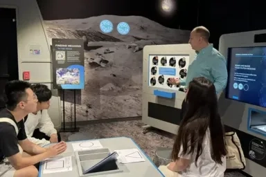 Students listening to a speaker at the Moonshot Museum