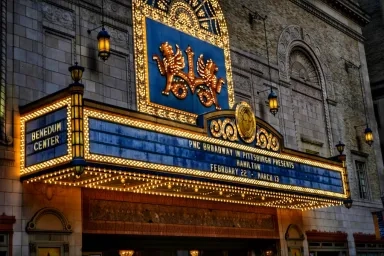 Illuminated marquee of the Benedum Center, showcasing "Hamilton" with show dates on the ornate facade