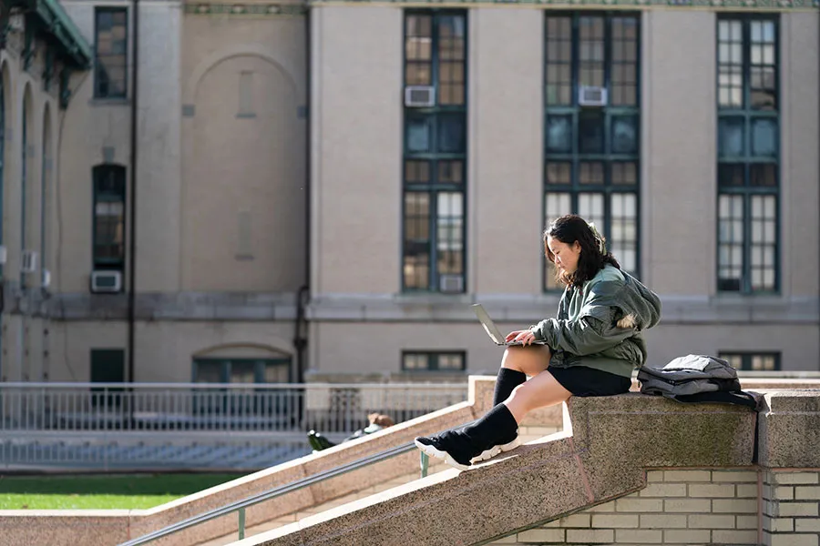 Scott Hall with student studying outside